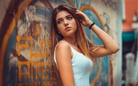 Brown hair girl, blue eyes, graffiti wall